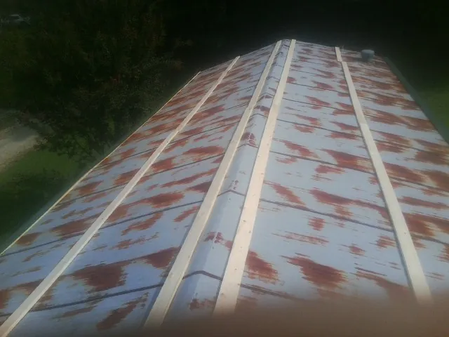 Rusted metal roof panels with new wood purlins before replacement — Storm Damage Roof Repair in Torrey by Roofing Brothers
