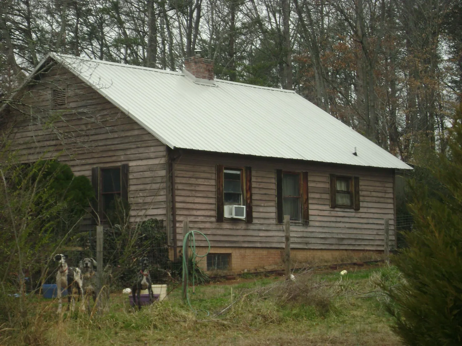 White metal roof on an old wood sided farmhouse, from a Metal Roof Installation job in Torrey